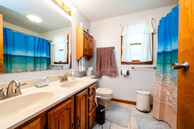 bathroom with tile patterned flooring, vanity, and toilet