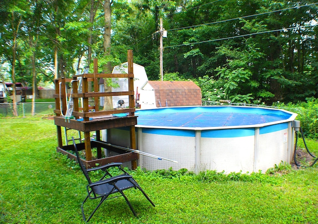 view of pool with a yard