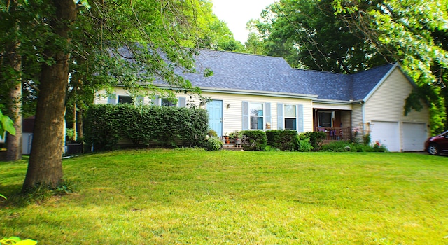 cape cod-style house featuring a garage and a front lawn