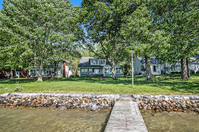 exterior space featuring a water view and a yard