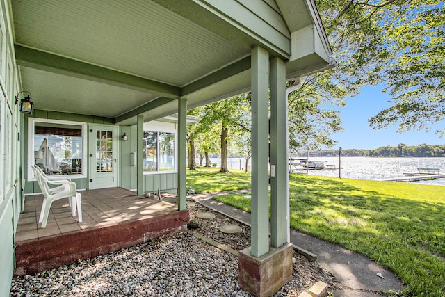 view of yard featuring a porch and a water view