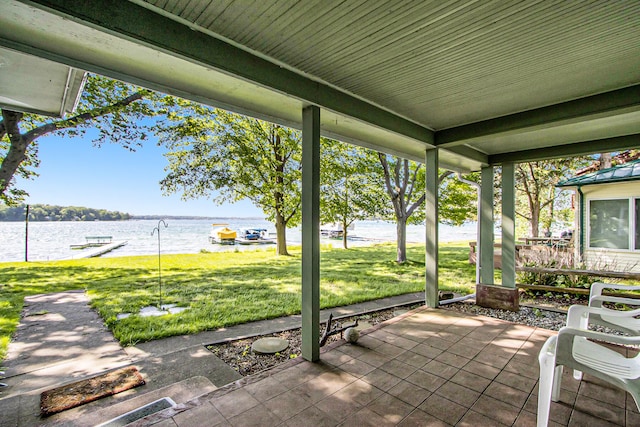 view of patio with covered porch and a water view