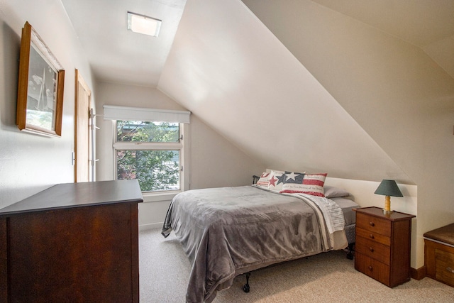 carpeted bedroom featuring vaulted ceiling