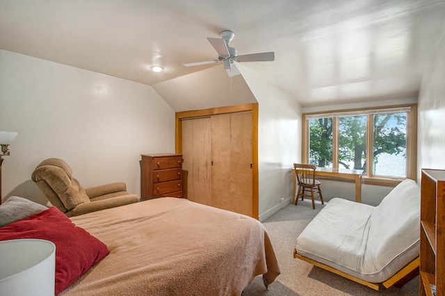 bedroom featuring light carpet, a closet, ceiling fan, and vaulted ceiling