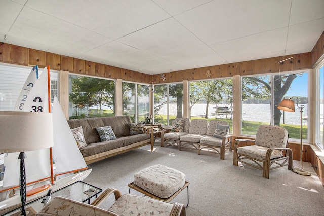 sunroom / solarium featuring a water view