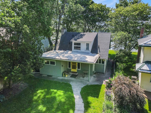 view of front of home with a front yard and a patio