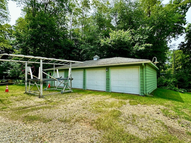 garage featuring a lawn