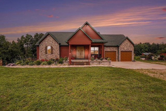 view of front facade with a porch, a yard, and a garage