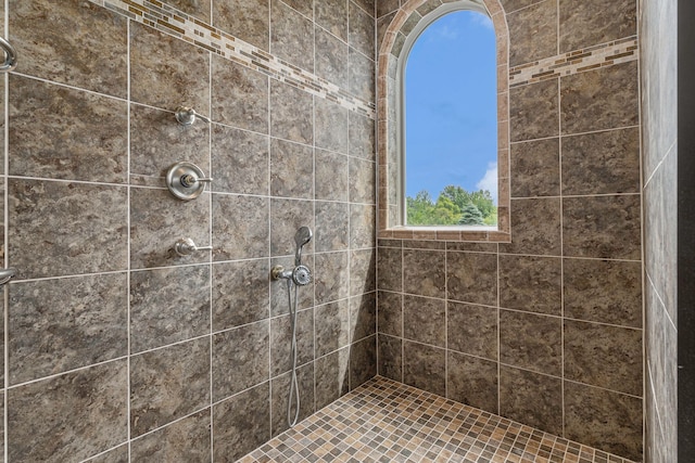 bathroom with tiled shower