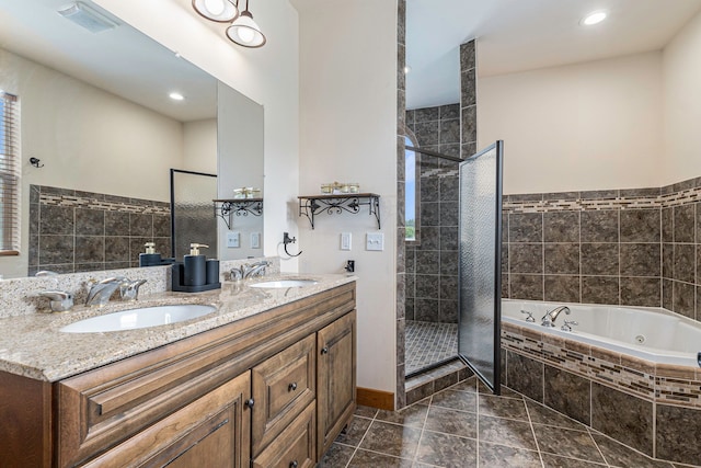 bathroom with vanity, tile patterned flooring, and plus walk in shower