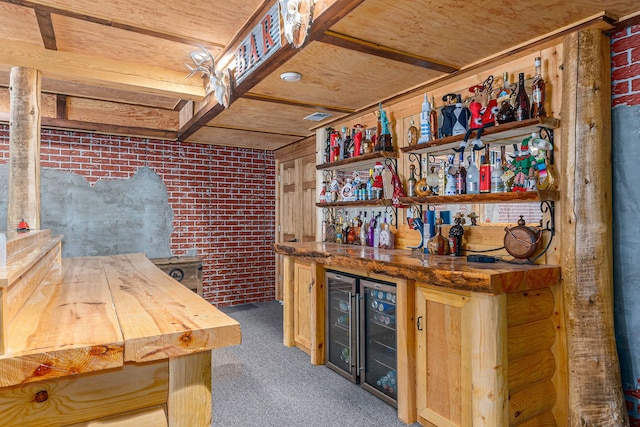 bar featuring wood counters, brick wall, light brown cabinetry, carpet, and wood ceiling