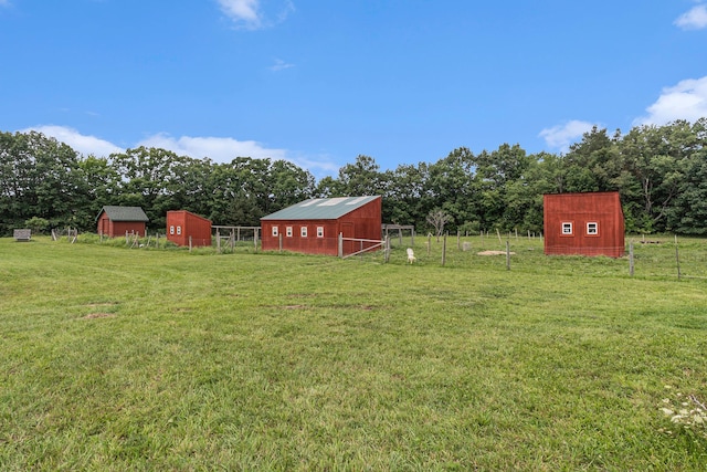 view of yard with a rural view and an outbuilding