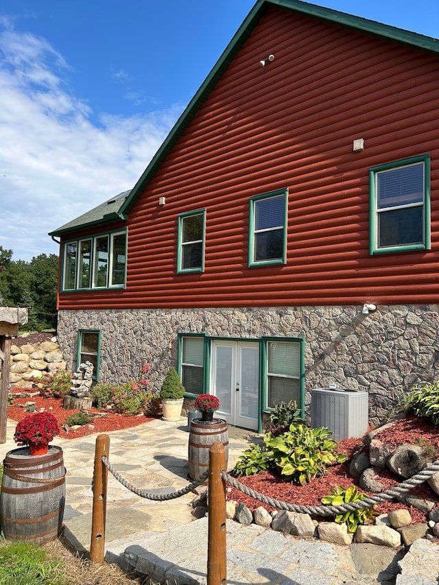 back of house featuring central air condition unit, french doors, and a patio