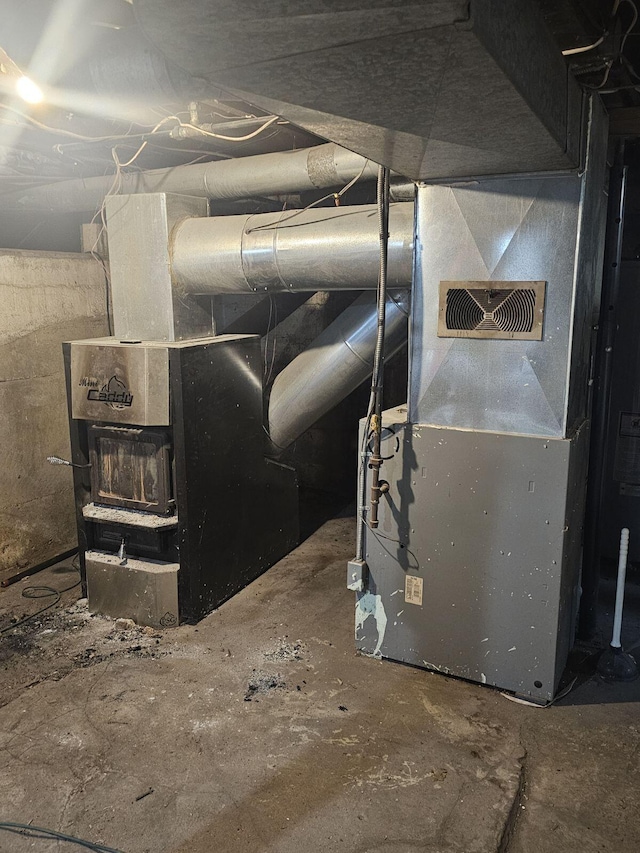 utility room featuring heating unit