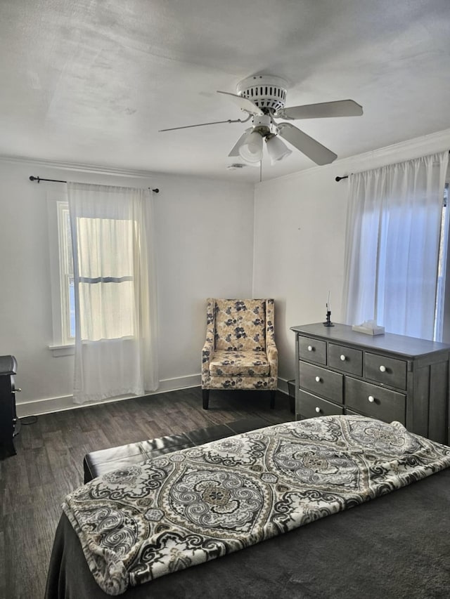 bedroom featuring dark wood-type flooring, a ceiling fan, and baseboards