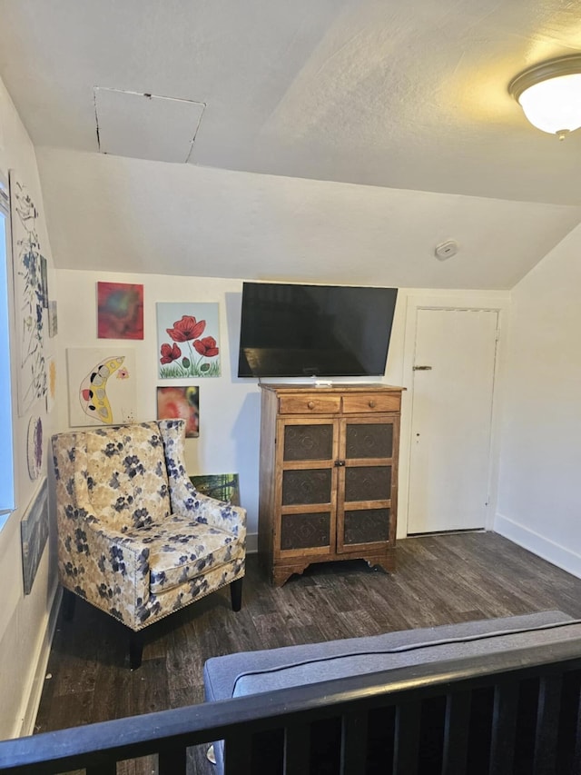 living area with baseboards, vaulted ceiling, and dark wood-style flooring