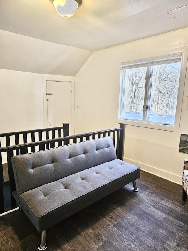 living area with baseboards, vaulted ceiling, and dark wood-style flooring