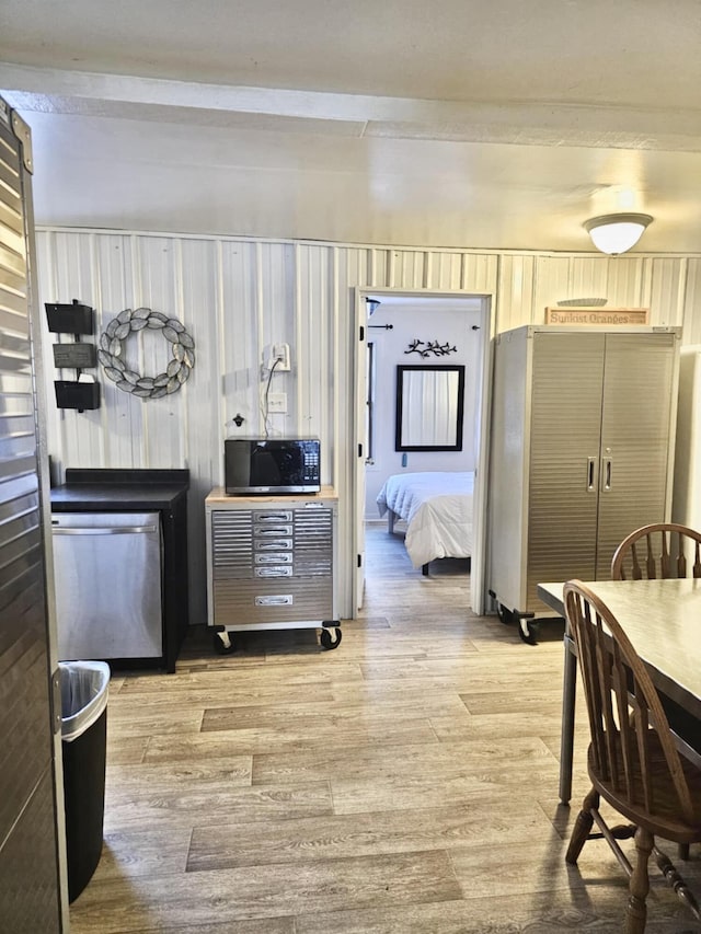 kitchen with light wood-style floors, black microwave, and dishwasher