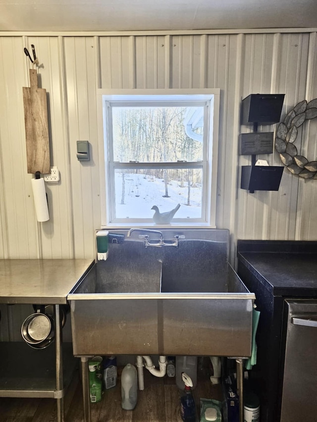 kitchen with dishwasher, a sink, and white cabinetry