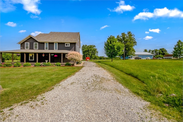 view of front of property with covered porch and a front lawn