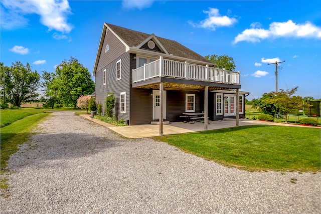 back of property featuring a patio area, a yard, a wooden deck, and french doors