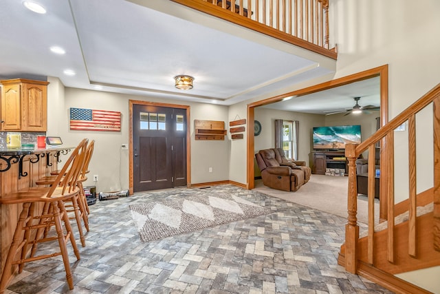 foyer entrance with a tray ceiling