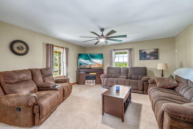 living room featuring light carpet, plenty of natural light, and ceiling fan