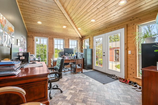 office area featuring wooden walls, french doors, high vaulted ceiling, and a healthy amount of sunlight