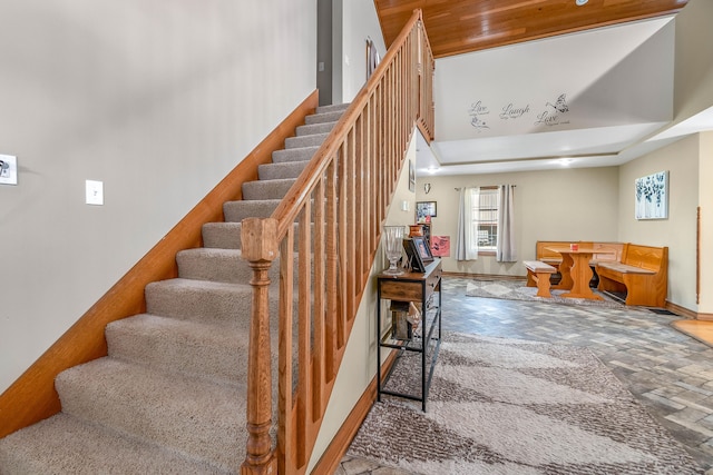 staircase featuring a high ceiling