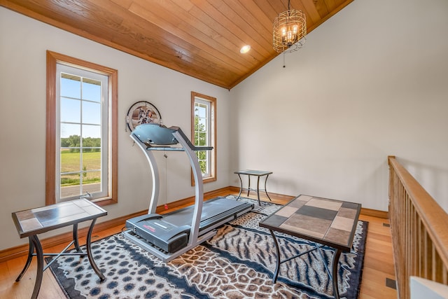 workout room with an inviting chandelier, wood ceiling, vaulted ceiling, and light wood-type flooring