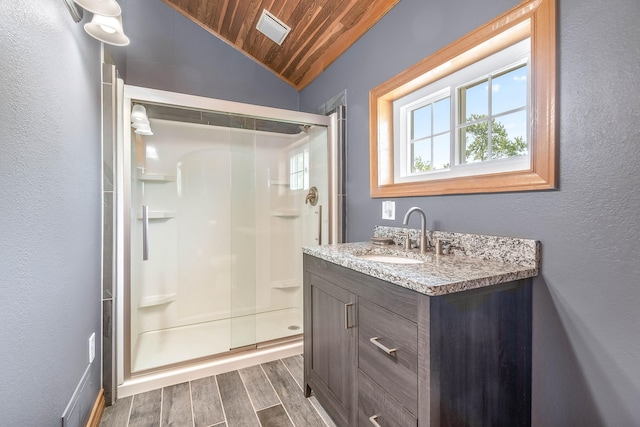 bathroom with walk in shower, vaulted ceiling, vanity, wood ceiling, and hardwood / wood-style flooring