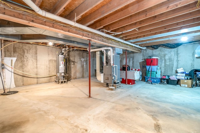 basement featuring gas water heater and heating unit