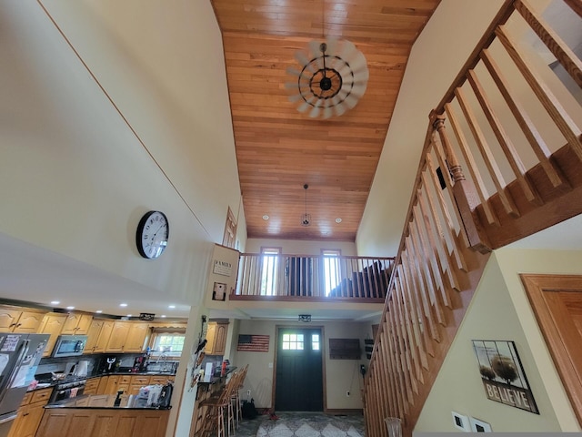 interior space with a towering ceiling and wood ceiling