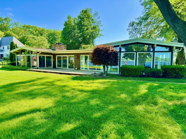 7206 Beechwood Cir, Watervliet, MI 49098 - rear view of house with a chimney and a lawn