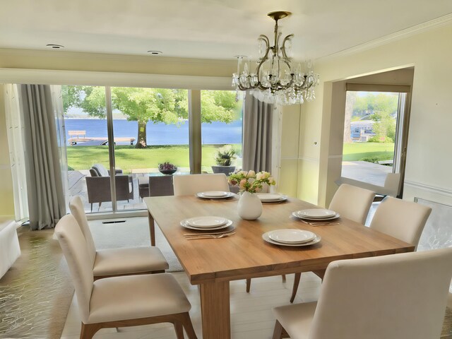 7206 Beechwood Cir, Watervliet, MI 49098 - dining room featuring a chandelier, crown molding, healthy amount of natural light, and a water view