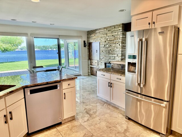 7206 Beechwood Cir, Watervliet, MI 49098 - kitchen featuring stainless steel appliances, white cabinetry, dark stone counters, and recessed lighting