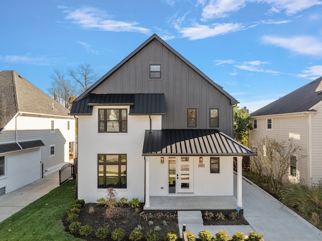 exterior space with a porch and french doors