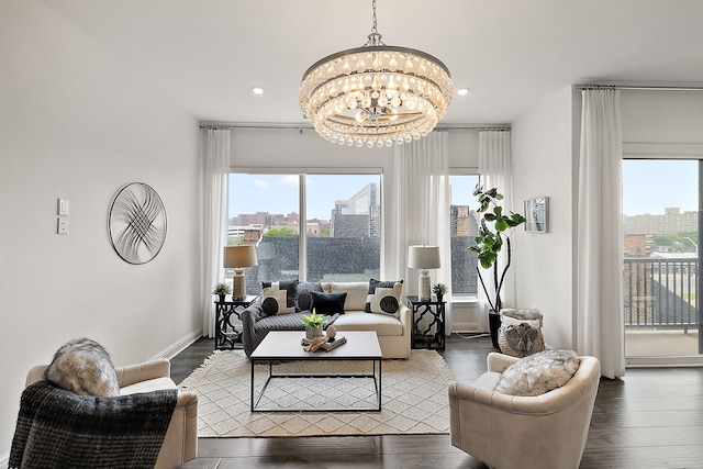 living room with an inviting chandelier and dark wood-type flooring