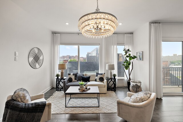 living room featuring plenty of natural light, wood finished floors, and a chandelier