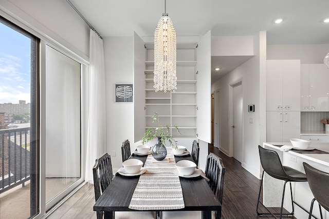 dining room featuring hardwood / wood-style flooring and an inviting chandelier