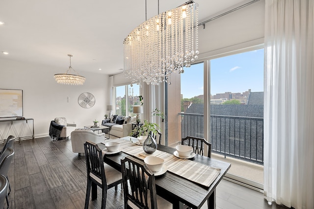 dining area with baseboards, wood finished floors, a view of city, and a chandelier