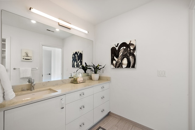 bathroom with vanity, baseboards, and visible vents