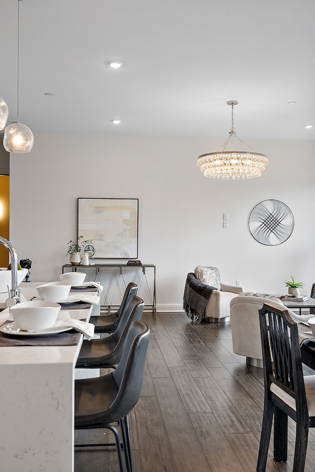 dining space featuring dark hardwood / wood-style floors and a notable chandelier