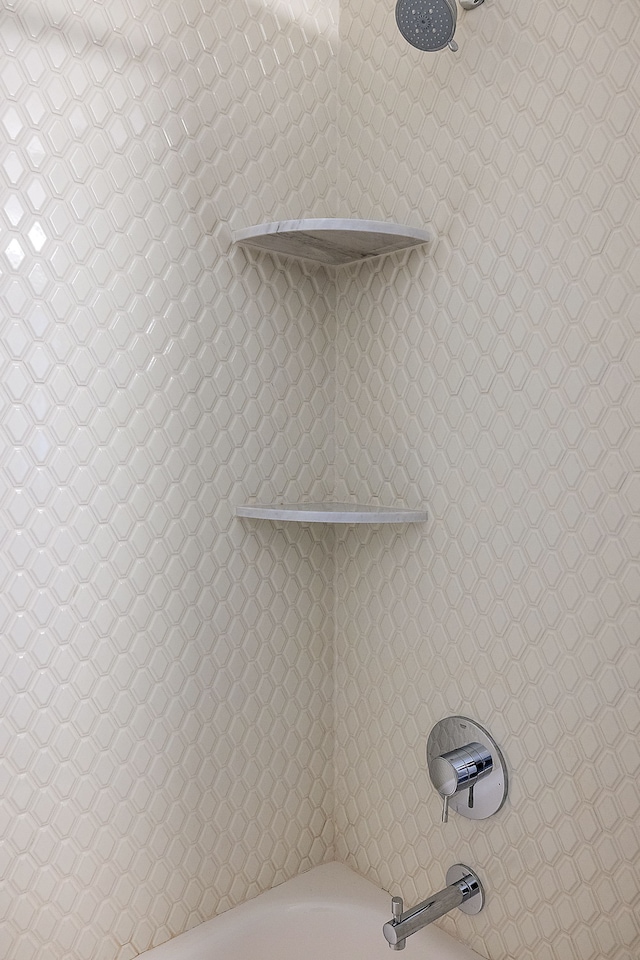 details featuring a bath and walk in shower