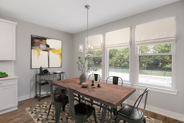 dining room with a chandelier and hardwood / wood-style floors