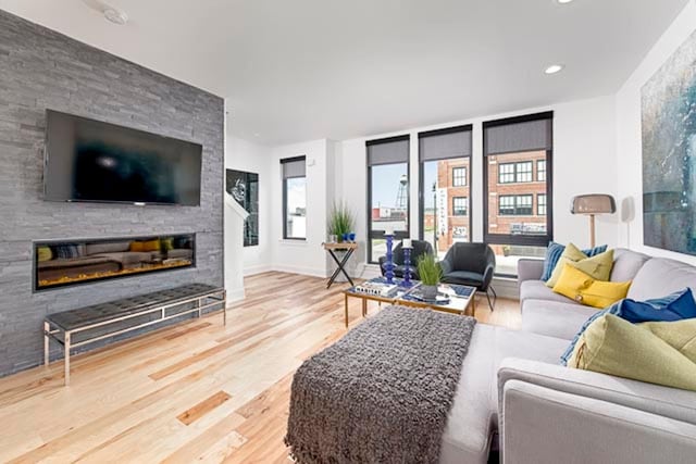 living room featuring wood-type flooring and a fireplace