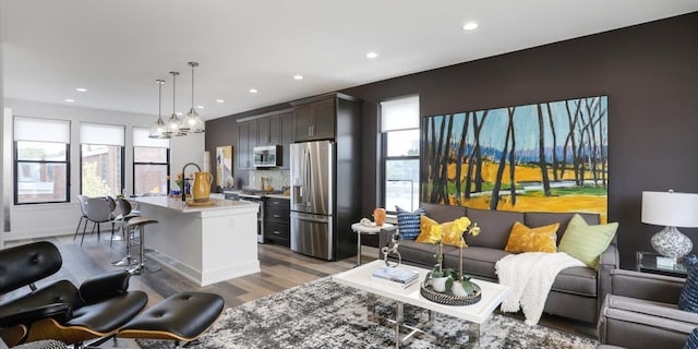 living room with hardwood / wood-style floors and a chandelier