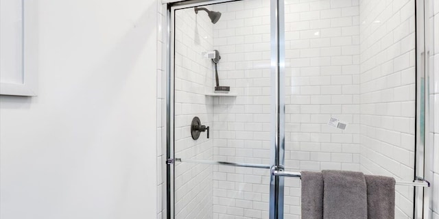 bathroom featuring a shower with door