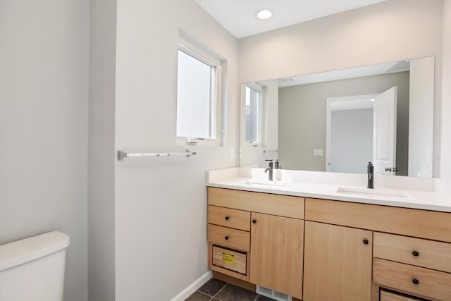 bathroom with tile patterned flooring, vanity, and toilet