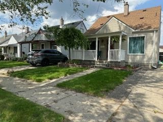 bungalow-style house with a porch and a front lawn